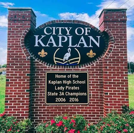 City of Kaplan welcome sign: brick pillars around the city seal with a heron and fleur-de-lis, and a plaque reading Home of the Kaplan High School Lady Pirates, State 3A Champions 2006 and 2016.
